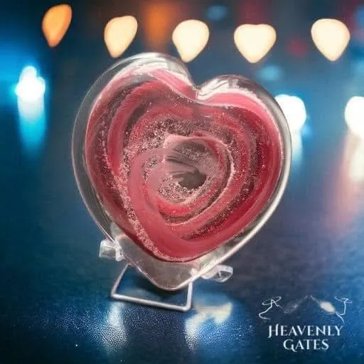 A pink glass heart swirled with sparkling white, on a clear stand.
