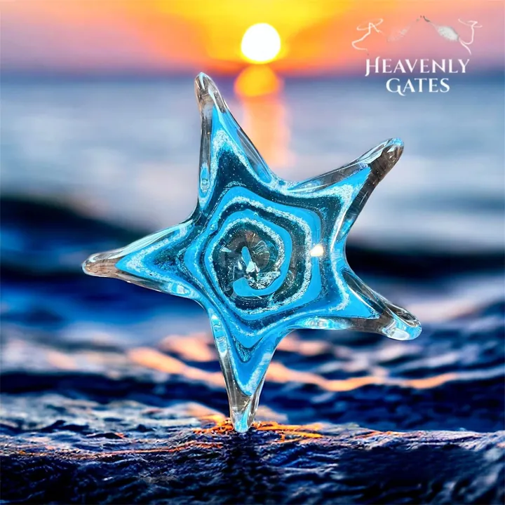 A blue glass starfish with a spiral of sparkling white at its center.