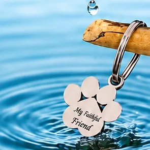 A paw-shaped silver keychain engraved My Faithful Friend.