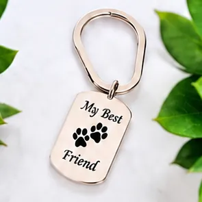 A silver tag keychain engraved My Best Friend, with a paw print.