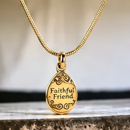 A gold oval pendant engraved Faithful Friend.