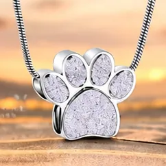 A silver paw print pendant filled with white sparkle.