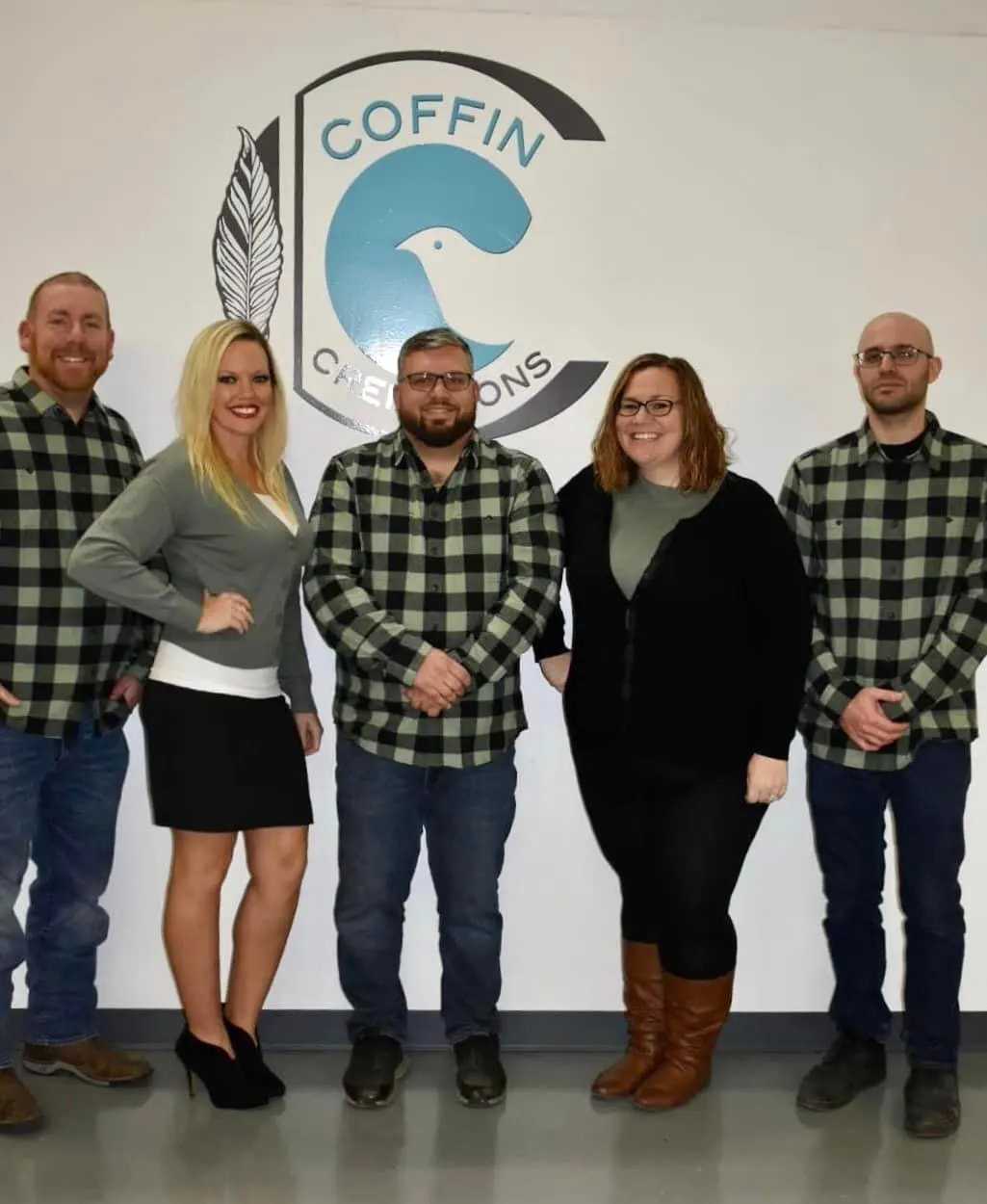 Five members of the Heavenly Gates team standing together in matching plaid shirts.